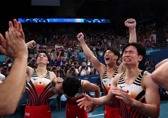 Japanese gymnasts celebrate after they won gold in the team competition on July 29. The Chinese team was in first place heading into the final rotation, but <a href=