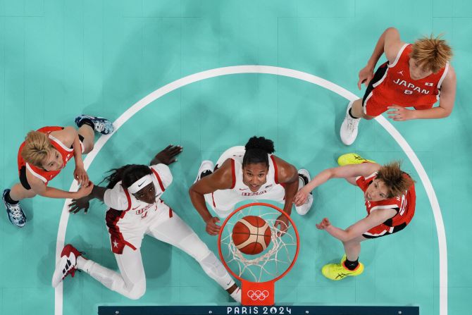 From left, Japan's Saori Miyazaki, the United States' Kahleah Copper, the United States' Alyssa Thomas, Japan's Saki Hayashi and Japan's Maki Takada watch the ball go through the hoop during their first basketball game in Paris on July 29. <a href=