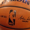 An NBA logo is seen on an official game ball before a game, Feb. 1, 2014, in New York. The NBA said Wednesday that it is not accepting Warner Bros. Discovery's $1.8 billion per year offer to continue its longtime relationship with the league and therefore has entered into a deal with Amazon Prime Video.