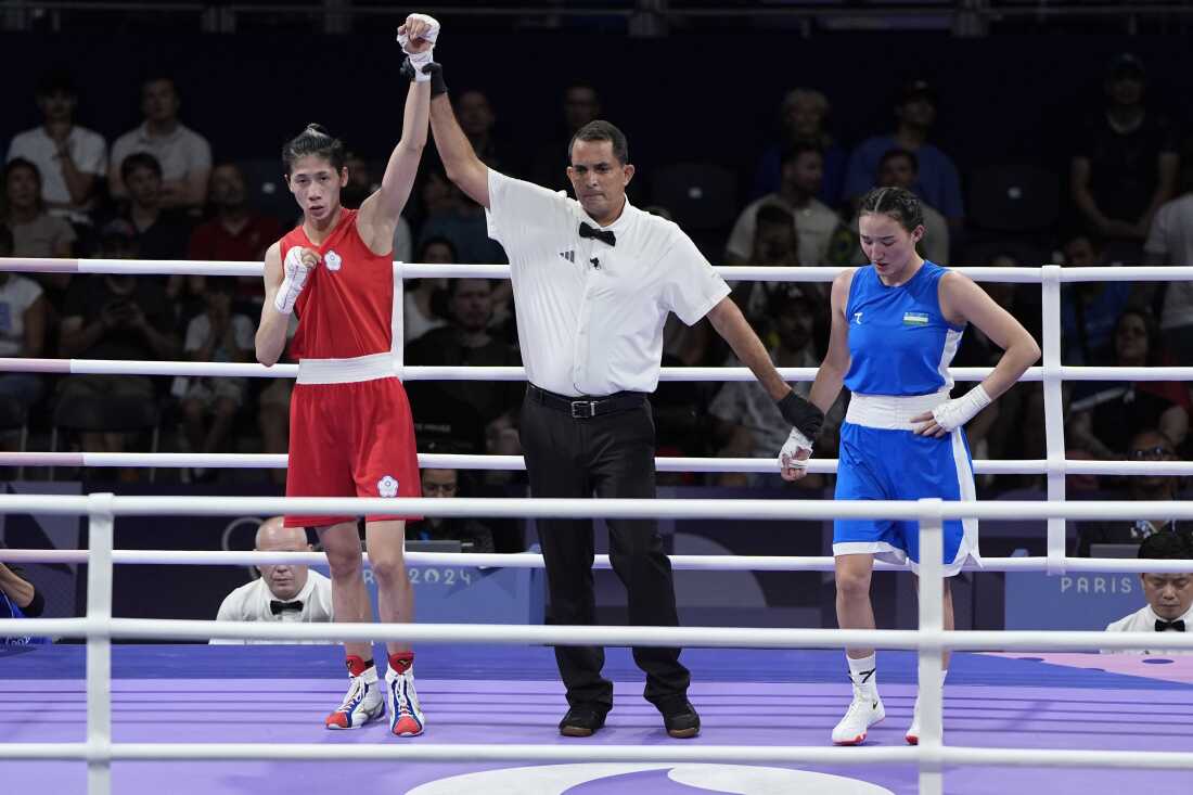 Taiwan's Lin Yu-ting, left, reacts after defeating Uzbekistan's Sitora Turdibekova in their women's 57 kg preliminary boxing match on Friday.