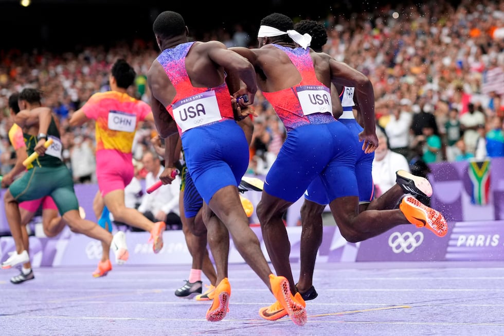 Christian Coleman, left, of the United States, struggles to hand the baton to teammate Kenneth...