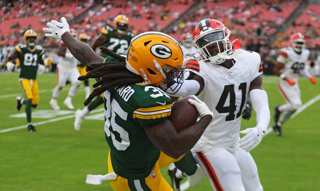 Green Bay Packers running back Jarveon Howard (35) is pushed out of bounds by Cleveland Browns safety Chris Edmonds (41) during the second half of an NFL preseason football game at Cleveland Browns Stadium, Saturday, Aug. 10, 2024, in Cleveland, Ohio.