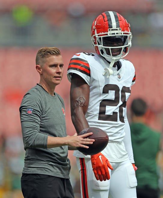 Cleveland Browns assistant wide receivers coach Callie Brownson watches warmups with Cleveland Browns cornerback Justin Hardee Sr. (28) before an NFL preseason football game at Cleveland Browns Stadium, Saturday, Aug. 10, 2024, in Cleveland, Ohio.