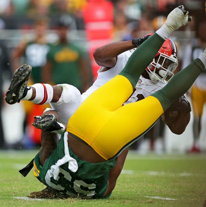 Cleveland Browns running back John Kelly Jr. (41) is brought down by Green Bay Packers defensive end Arron Mosby (53) during the second half of an NFL preseason football game at Cleveland Browns Stadium, Saturday, Aug. 10, 2024, in Cleveland, Ohio.