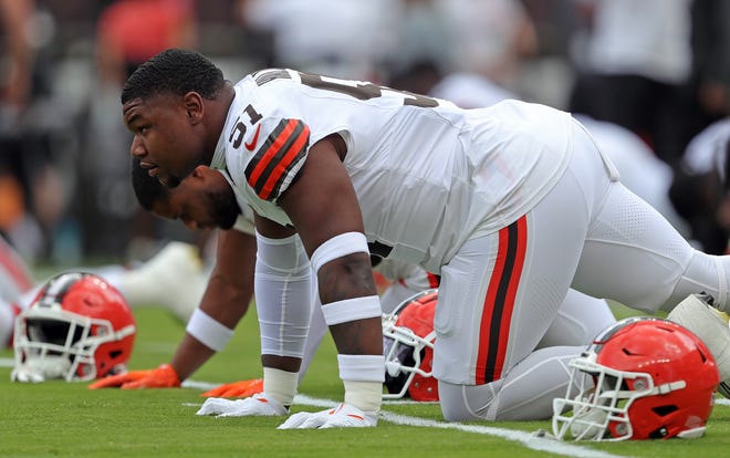 Cleveland Browns defensive tackle Mike Hall Jr. (51) stretches before an NFL preseason football game at Cleveland Browns Stadium, Saturday, Aug. 10, 2024, in Cleveland, Ohio.