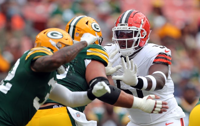 Cleveland Browns defensive tackle Mike Hall Jr. (51) works around a pair of Green Bay Packers players during the first half of an NFL preseason football game at Cleveland Browns Stadium, Saturday, Aug. 10, 2024, in Cleveland, Ohio.