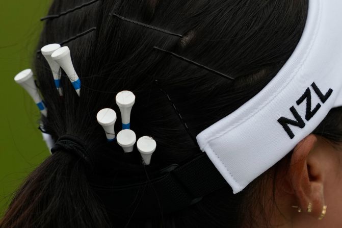 New Zealand's Lydia Ko carries spare tees in her hair during the third round of the women's golf tournament on August 9. Ko and Switzerland’s Morgane Métraux <a href=