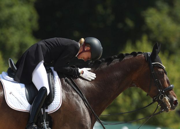 Germany's Jessica von Bredow-Werndl pets her horse TSF Dalera BB after <a href=