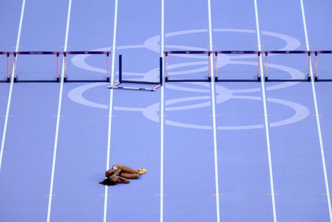 British hurdler Lina Nielsen lies on the track after falling during a semifinal race on August 6.