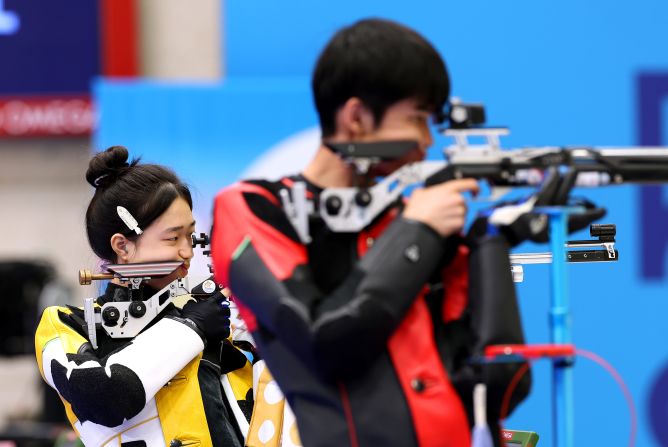 China’s Huang Yuting, left, competes in the 10-meter air rifle mixed-team shooting competition with Sheng Lihao on July 27. <a href=