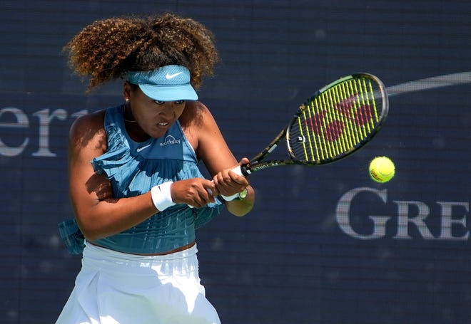 Naomi Osaka returns a hit to Ashlyn Krueger in the women's singles qualifying round 2 during the Cincinnati Open at the Lindner Family Tennis Center in Mason Monday, August 12, 2024. Krueger won 6,-3, 2-6,6-3.