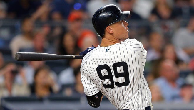 Yankees rightfielder Aaron Judge (99) follows through on a solo home run during the fifth inning of the Tigers' 7-3 loss on Monday, July 31, 2017, in New York.