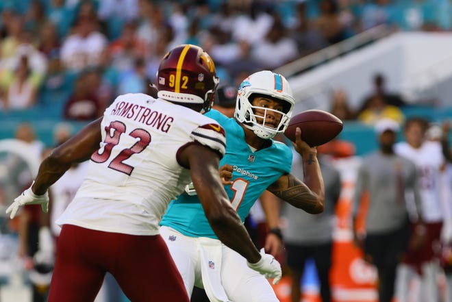 Aug 17, 2024; Miami Gardens, Florida, USA; Miami Dolphins quarterback Tua Tagovailoa (1) passes the football against the Washington Commanders during the first quarter of a preseason game at Hard Rock Stadium. Mandatory Credit: Sam Navarro-USA TODAY Sports