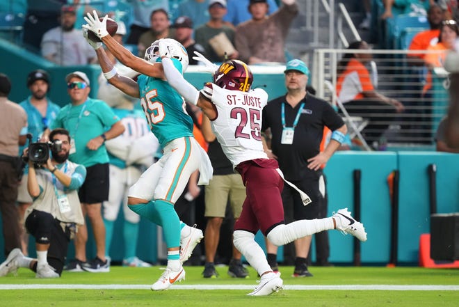 Aug 17, 2024; Miami Gardens, Florida, USA; Miami Dolphins wide receiver River Cracraft (85) catches a touchdown over Washington Commanders cornerback Benjamin St-Juste (25) during the first quarter at Hard Rock Stadium. Mandatory Credit: Jim Rassol-USA TODAY Sports