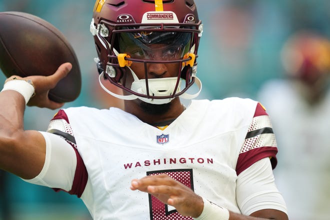 Aug 17, 2024; Miami Gardens, Florida, USA; Washington Commanders quarterback Jayden Daniels (5) warms up before the preseason game against the Miami Dolphins at Hard Rock Stadium. Mandatory Credit: Jim Rassol-USA TODAY Sports