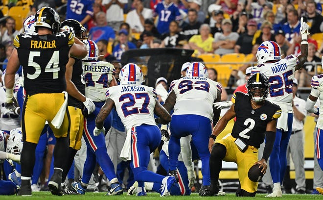 Justin Fields (2) of the Pittsburgh Steelers kneels on the field as the Buffalo Bills celebrate after a turnover on down in the third quarter during the preseason game at Acrisure Stadium on August 17, 2024 in Pittsburgh, Pennsylvania.