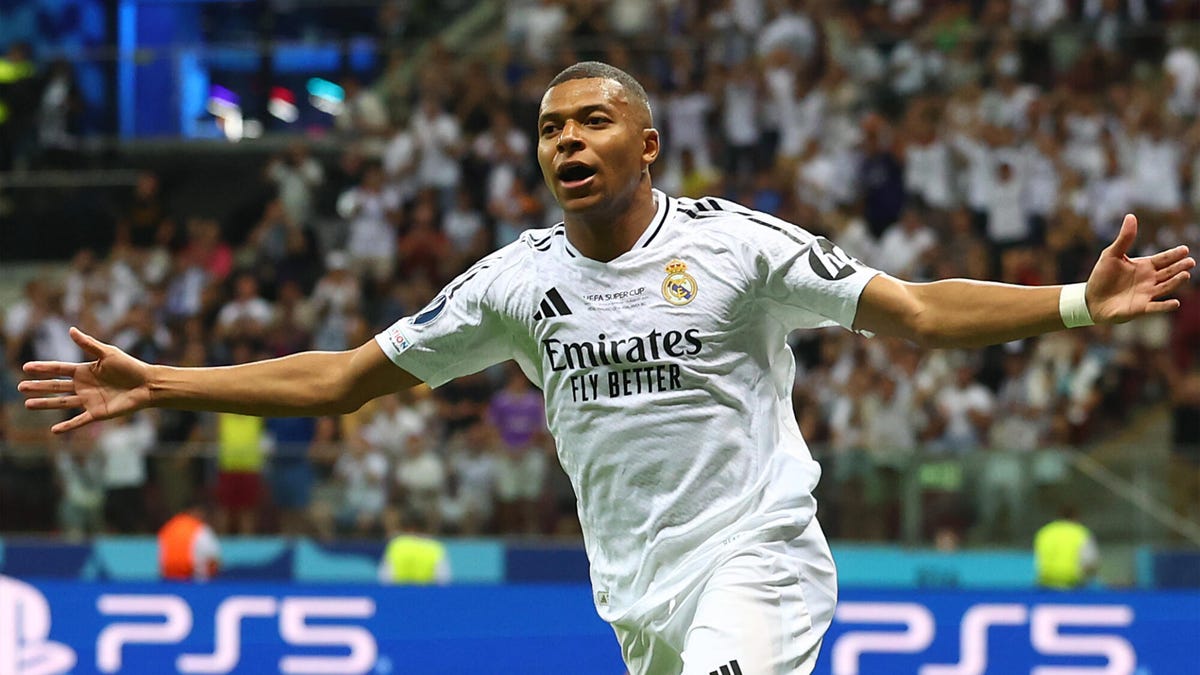 Kylian Mbappe of Real Madrid celebrating with both arms outstretched.