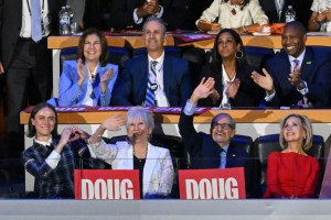 (L-R) Daughter of US Second Gentleman Douglas Emhoff Ella Emhoff, mother Barbara Emhoff, father Michael Emhoff, and Tim Walz's wife Gwen Walz watch as Second Gentleman Douglas Emhoff speaks on the second day of the Democratic National Convention (DNC) at the United Center in Chicago, Illinois, on August 20, 2024. Vice President Kamala Harris will formally accept the party's nomination for president at the DNC which runs from August 19-22 in Chicago. (Photo by Eva HAMBACH / AFP) (Photo by EVA HAMBACH/AFP via Getty Images). thom browne outfit