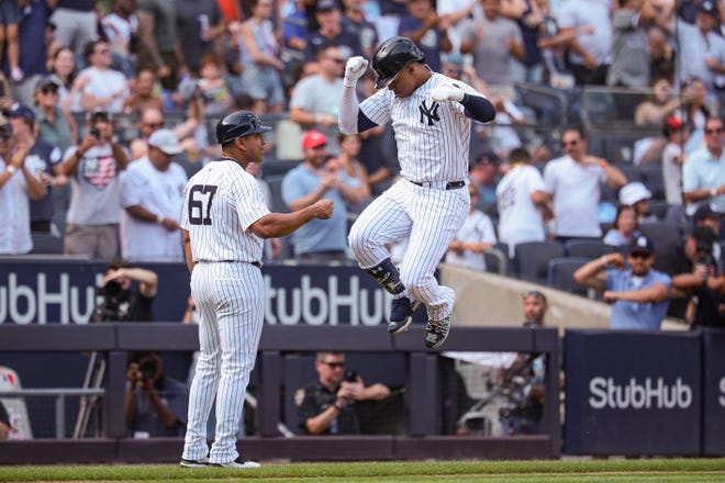 Aug 11, 2024; Bronx, New York, USA; New York Yankees right fielder Juan Soto (22) celebrates while rounding the bases during his solo home run during the seventh inning against the Texas Rangers at Yankee Stadium. Mandatory Credit: Vincent Carchietta-USA TODAY Sports