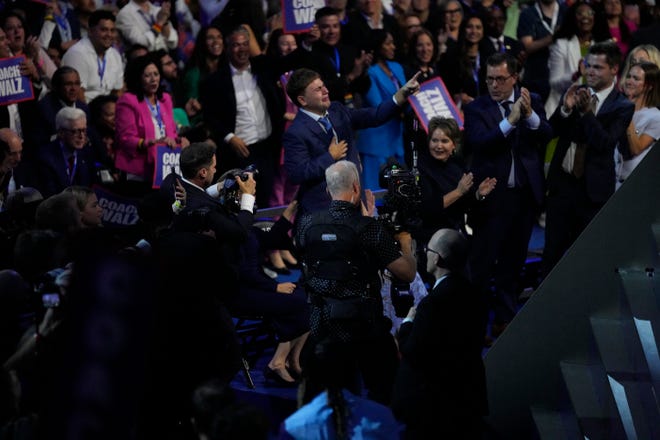 Gus Walz reacts as his father, Democratic Vice Presidential nominee Tim Walz, gives an acceptance speech during the third day of the Democratic National Convention at the United Center.