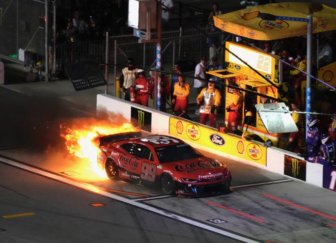 Daniel Suarez's No. 99 Chevrolet catches fire on pit road during the Coke Zero Sugar 400, Saturday, Aug. 24, 2024, at Daytona International Speedway.