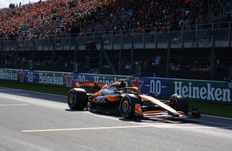 F1 driver crosses finish line.