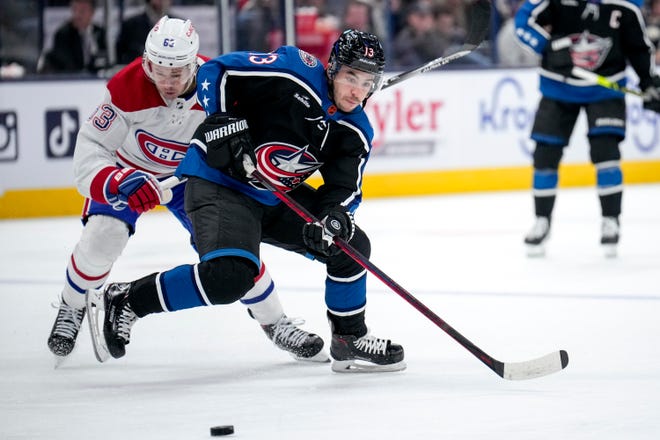 Nov 23, 2022; Columbus, Ohio, United States; Columbus Blue Jackets forward Johnny Gaudreau (13) fights with Montreal Canadiens forward Evgenii Dadonov (63) for the puck during the second period of the NHL hockey game between the Columbus Blue Jackets and the Montreal Canadiens at Nationwide Arena. Mandatory Credit: Joseph Scheller-The Columbus Dispatch