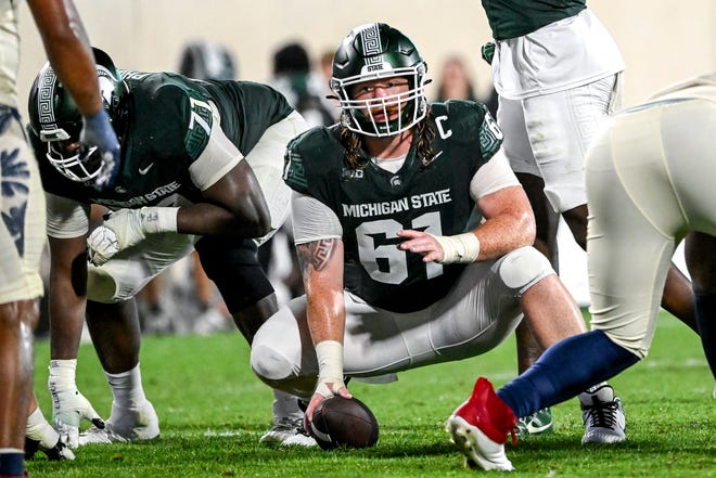 Michigan State's Tanner Miller prepares to snap the ball in the game against Florida Atlantic during the fourth quarter on Friday, Aug. 30, 2024, at Spartan Stadium in East Lansing.