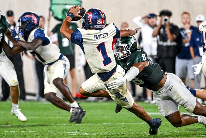 Michigan State's Anthony Jones, right, tackles Florida Atlantic's Cam Fancher during the fourth quarter on Friday, Aug. 30, 2024, at Spartan Stadium in East Lansing.