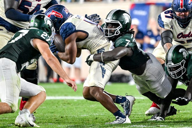 Michigan State's Jordan Turner, right, tackles Florida Atlantic's CJ Campbell, Jr. during the fourth quarter on Friday, Aug. 30, 2024, at Spartan Stadium in East Lansing.