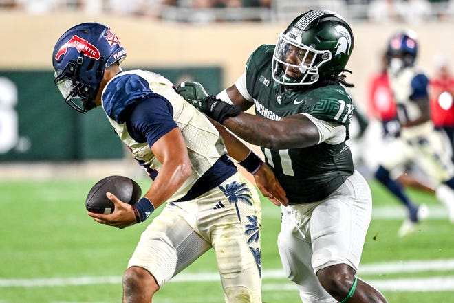 Michigan State's Ken Talley, right, tackles Florida Atlantic's Cam Fancher for a loss on fourth down during the fourth quarter on Friday, Aug. 30, 2024, at Spartan Stadium in East Lansing.