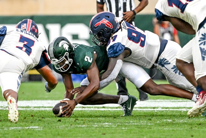 Michigan State's Aidan Chiles recovers a fumble against Florida Atlantic during the first quarter on Friday, Aug. 30, 2024, at Spartan Stadium in East Lansing.