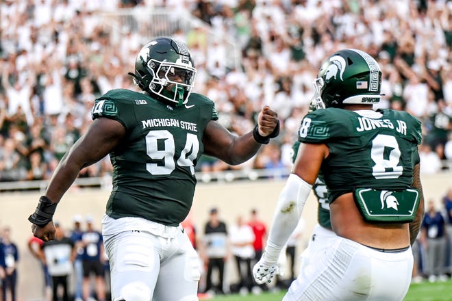 Michigan State's D'Quan Douse, left, celebrates his safety with teammate Anthony Jones during the first quarter in the game against Florida Atlantic on Friday, Aug. 30, 2024, at Spartan Stadium in East Lansing.