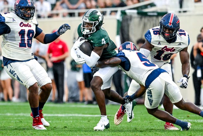 Michigan State's Jaron Glover, left, runs after a catch as Florida Atlantic's Jayden Williams closes in during the first quarter on Friday, Aug. 30, 2024, at Spartan Stadium in East Lansing.