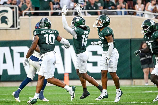 Michigan State's Angelo Grose, center celebrates his interception against Florida Atlantic with teammates Wayne Matthews III, left, and Nikai Martinez during the second quarter on Friday, Aug. 30, 2024, at Spartan Stadium in East Lansing.