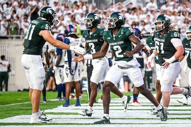 Michigan State's Aidan Chiles, right, celebrates his touchdown with Michael Masunas during the second quarter in the game against Florida Atlantic on Friday, Aug. 30, 2024, at Spartan Stadium in East Lansing.