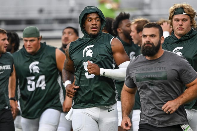 Michigan State's Jordan Hall, center, and the rest of the Spartans head back to the locker room before the game against Florida Atlantic on Friday, Aug. 30, 2024, at Spartan Stadium in East Lansing.