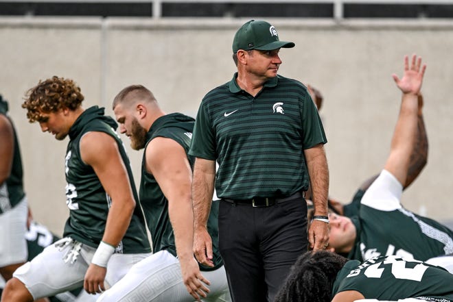 Michigan State's head coach Jonathan Smith looks on during team warm ups before the game against Florida Atlantic on Friday, Aug. 30, 2024, at Spartan Stadium in East Lansing.