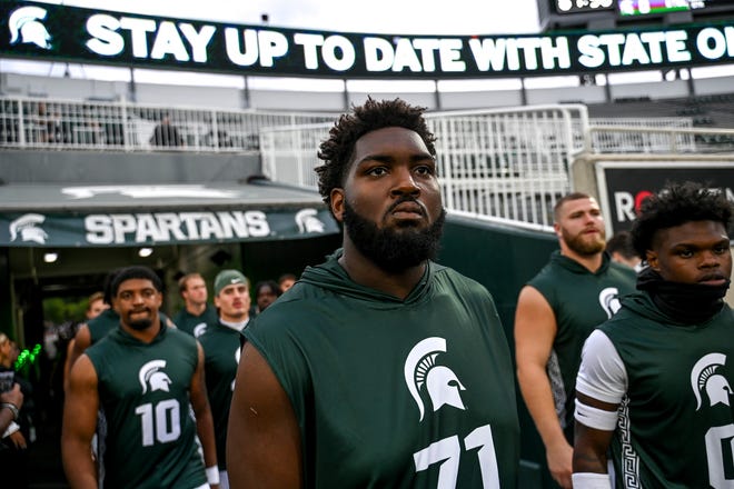 Michigan State's Kristian Phillips and the Spartans take the field for warm ups before the game against Florida Atlantic on Friday, Aug. 30, 2024, at Spartan Stadium in East Lansing.