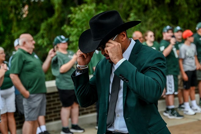 Michigan State's Dillon Tatum adjusts his sunglasses while walking with the team to Spartan Stadium before the game against Florida Atlantic on Friday, Aug. 30, 2024, in East Lansing.