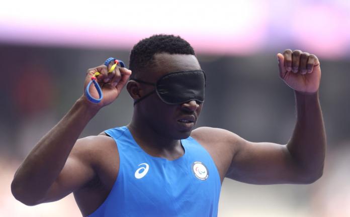 Team Refugee athlete Guillaume Junior Atangana, who is wearing a blue vest and a blindfold, celebrates qualifying for the semi-finals at Paris 2024