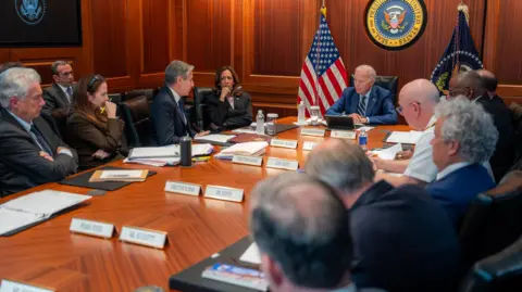 White House/ X President Joe Biden sits in the Situation Room with national security officials