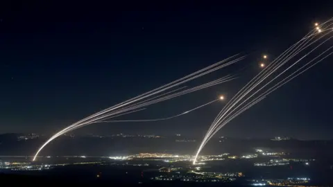 EPA Projectiles fired from the Israeli Iron Dome air defense system to intercept missiles fired from southern Lebanon, over the upper Galilee, northern Israel, early 04 August 2024. 