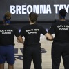 Minnesota Lynx players lock arms during a moment of silence in honor of Breonna Taylor before a game on in July 2020. Their black shirts say 