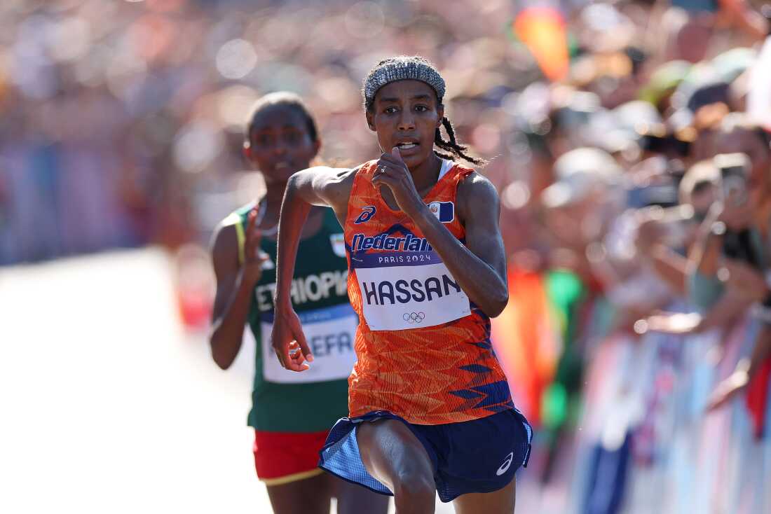 Sifan Hassan of the Netherlands stays ahead of Ethiopia's Tigst Assefa at the finish of the women's marathon on Sunday at the Paris Olympics. Hassan won gold, adding to two bronzes she won in the 5,000 and 10,000 meter races.