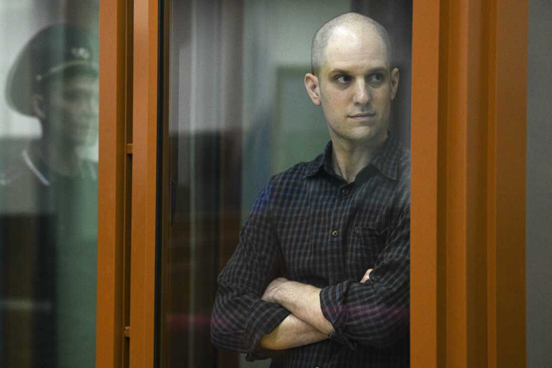 Wall Street Journal reporter Evan Gershkovich stands in a glass cage in a courtroom in Yekaterinburg, Russia, Wed., June 26, 2024.