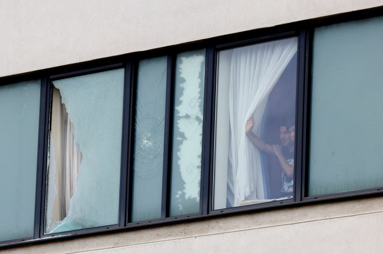 People look out from inside a hotel window in Rotherham