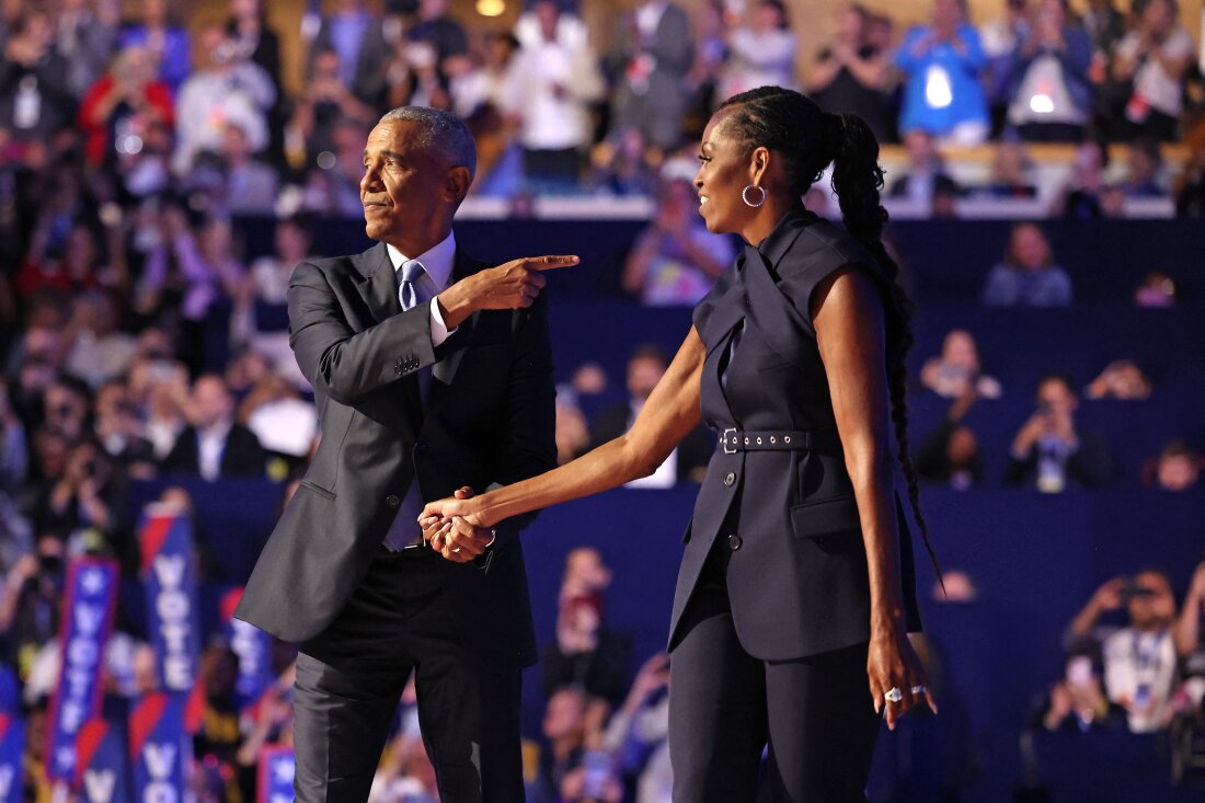 Former First Lady Michelle Obama (R) introduces former President Barack Obama on the second day of the Democratic National Convention at the United Center in Chicago, Illinois, on August 20, 2024. 