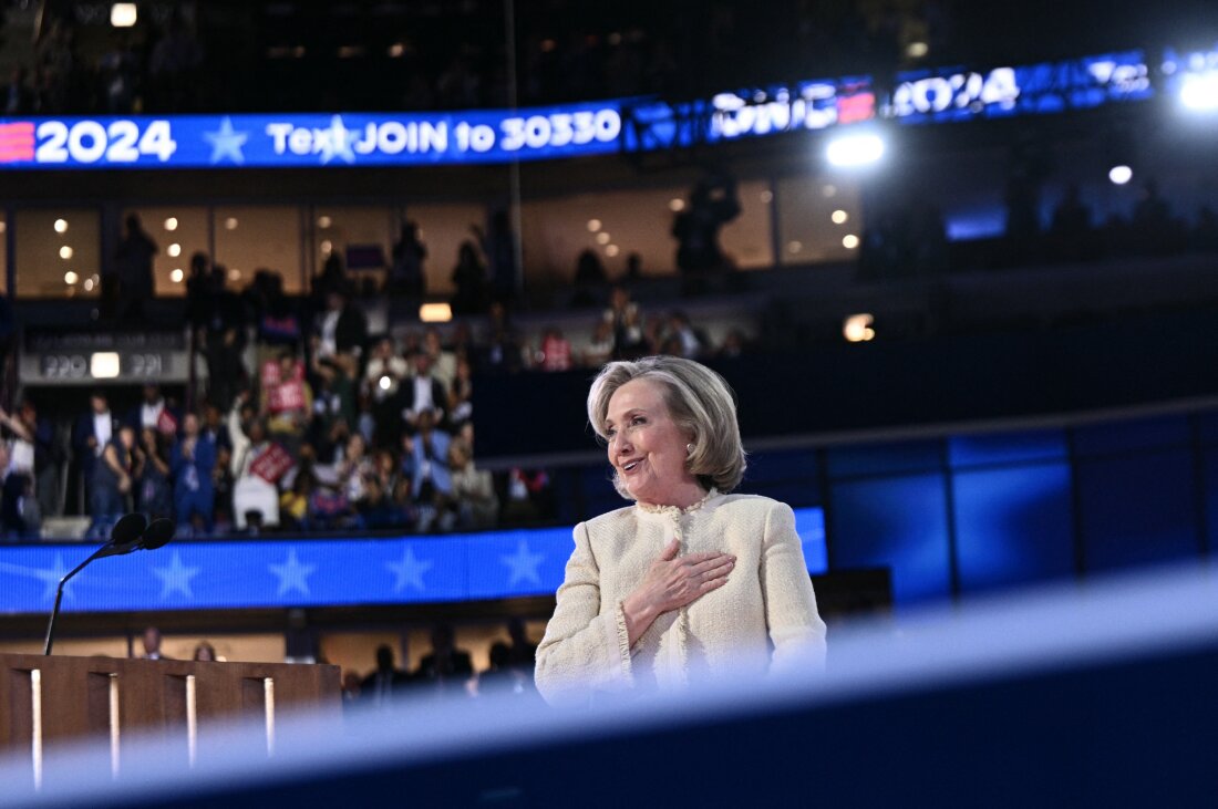 Former US Secretary of State Hillary Clinton salutes the attendees as she steps off stage after speaking on the first day of the Democratic National Convention.