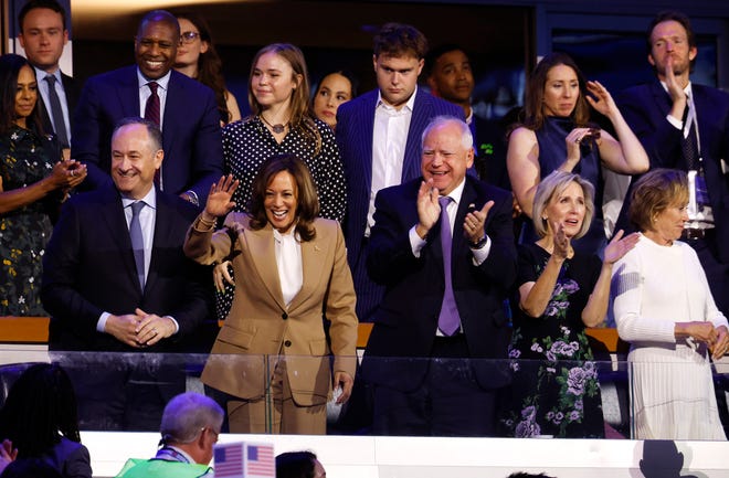 CHICAGO - Vice President Kamala Harris and her running mate Minnesota Gov. Tim Walz are flanked by their family members during the first day of the DNC, August 19, 2024. Walz' son Tim is behind him.